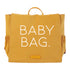 butterscotch bag with canvas material and vegan leather handle that says baby bag