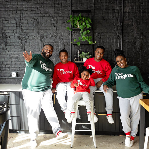 Family Matching in kitchen wearing sweatshirts adult in green and kids in red sweatshirts for holiday matching shirts
