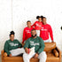 black family matching holiday green sweatshirts and kids wearing red sweatshirts with design text that say the original, the remix, the encore, micdrop.