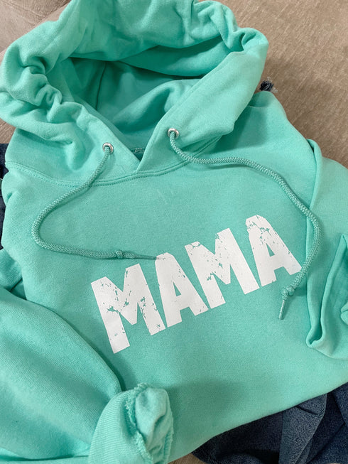 flat lay of hoodie ocean blue color with a distressed mama screen print design cute and cozy hoodie for women or mothers