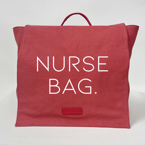 coral color bag back pack that says nurse bag on the front flap