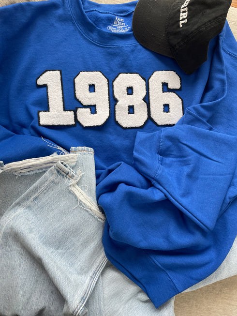 Rotal Blue Sweatshirt with White and Black Lining Chenille Patch numbers.
