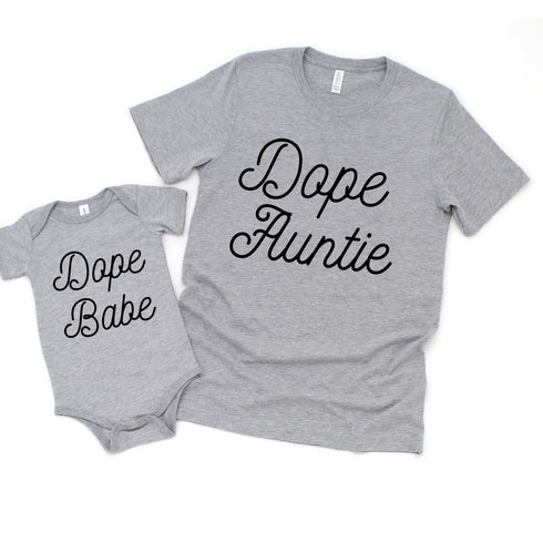 baby and adult matching shirts, color is heather grey with black ink, screen print says dope auntie and dope babe for matching adult and baby shirts